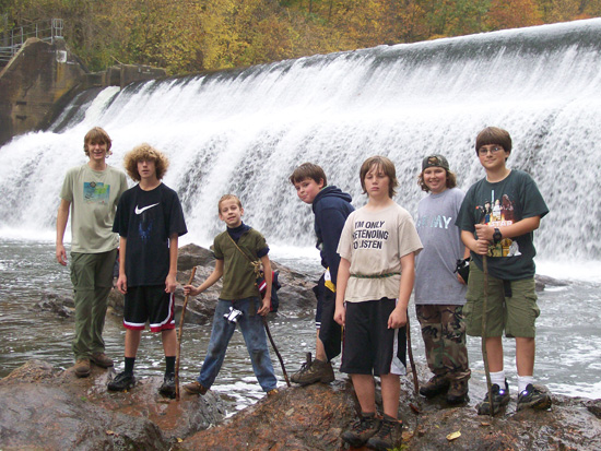 Scouts posting in front of a waterfall