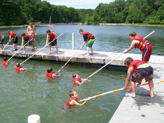 Scouts practicing life saving techniques at summer camp